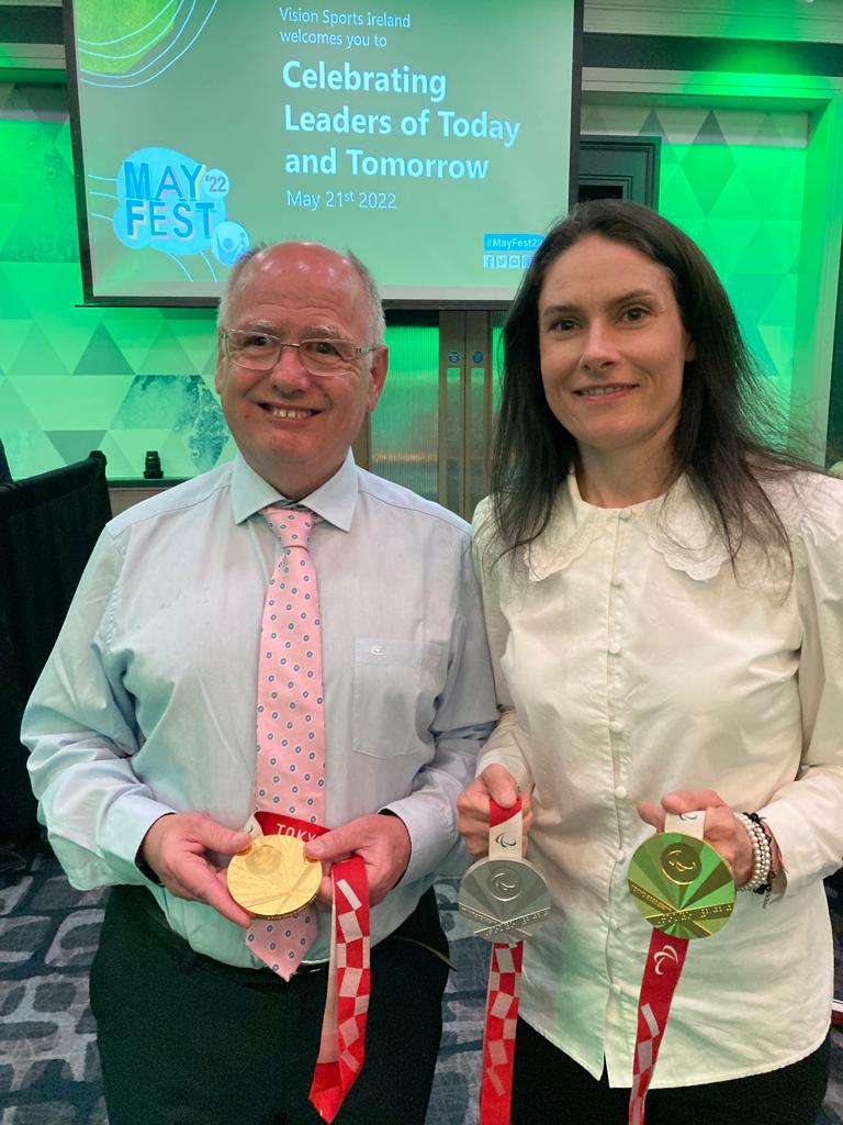 Katie-George Dunlevy and Joe holding her medals.